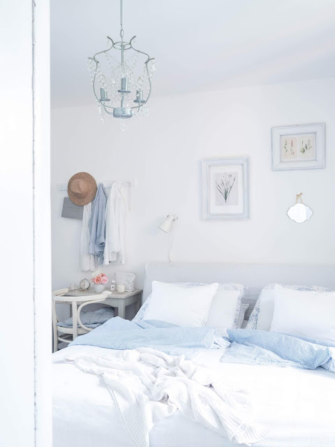 bílá ložnice se světlými dekoracemi